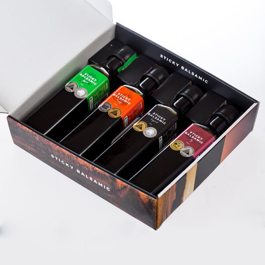 Sticky Balsamic premium gift box featuring four gourmet balsamic vinegar bottles — Original, Fig, Truffle and Pear — elegantly packaged for gifting.