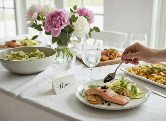 A Mother’s Day table set with flowers and a “Mum” place card as balsamic pearls are spooned onto salmon with a small balsamic drip