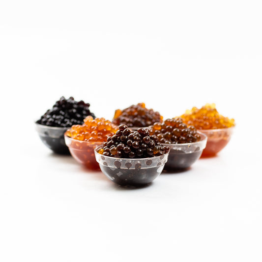 Sticky Balsamic Pearls in plastic containers, showing the size and shape of the pearls.