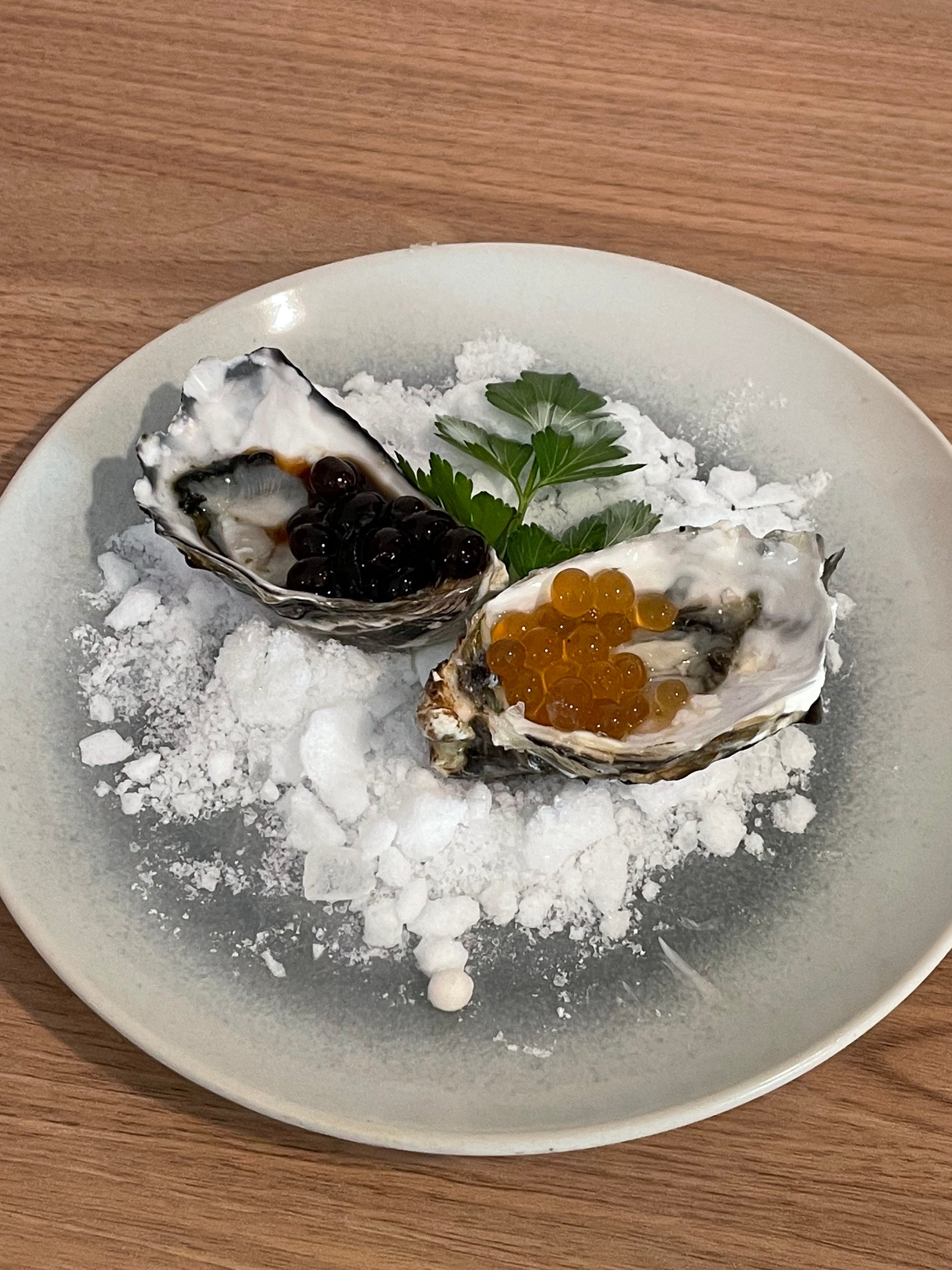Oyster with sticky balsamic pearls on crushed ice