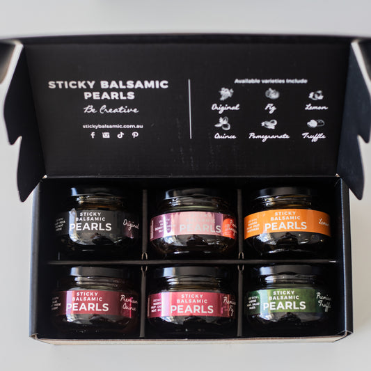 Sticky balsamic pearls gift box open with six labeled jars inside