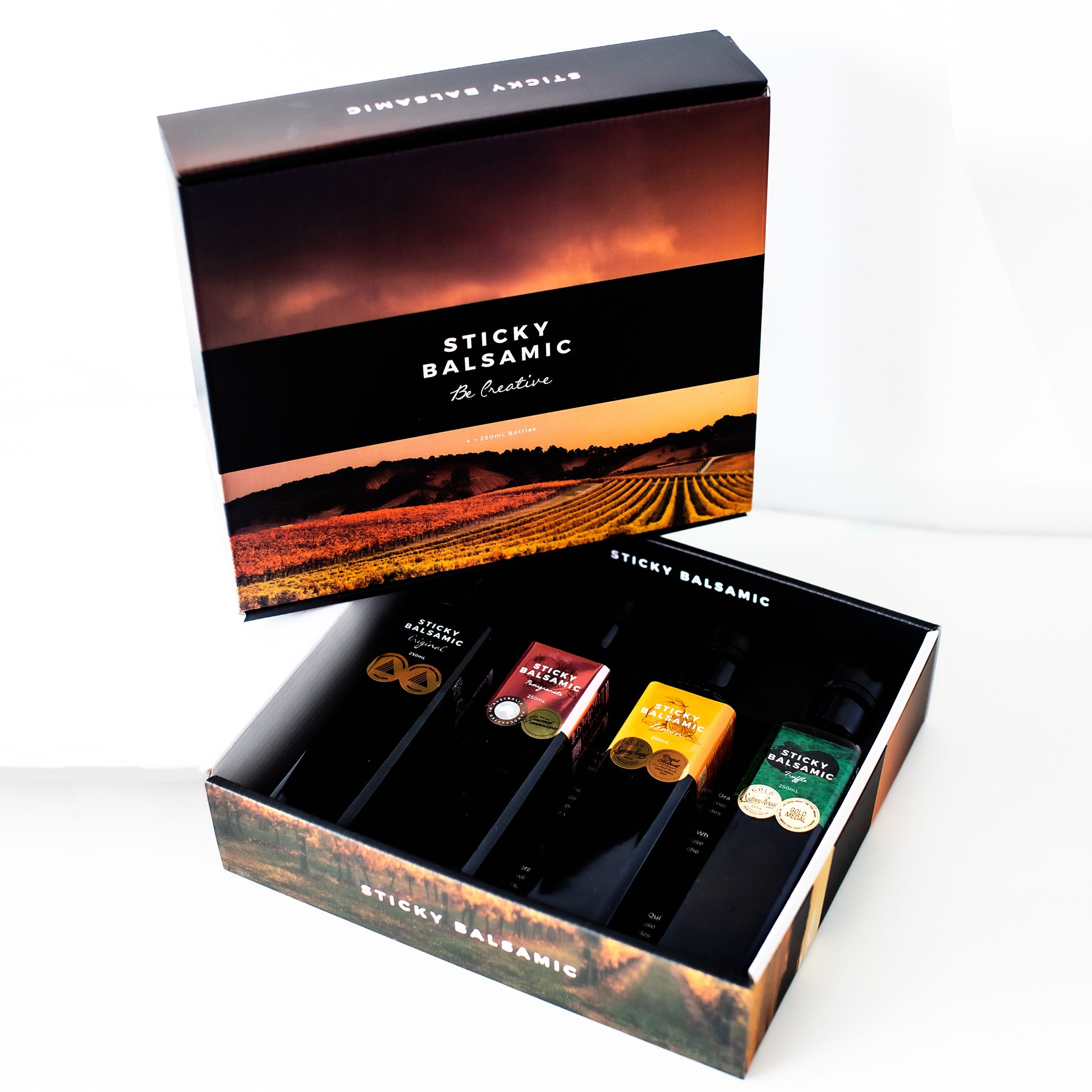 Balsamic bottle gift box open with several balsamic bottles in a branded outer case