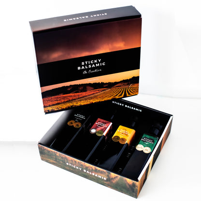 Balsamic bottle gift box open with several balsamic bottles in a branded outer case