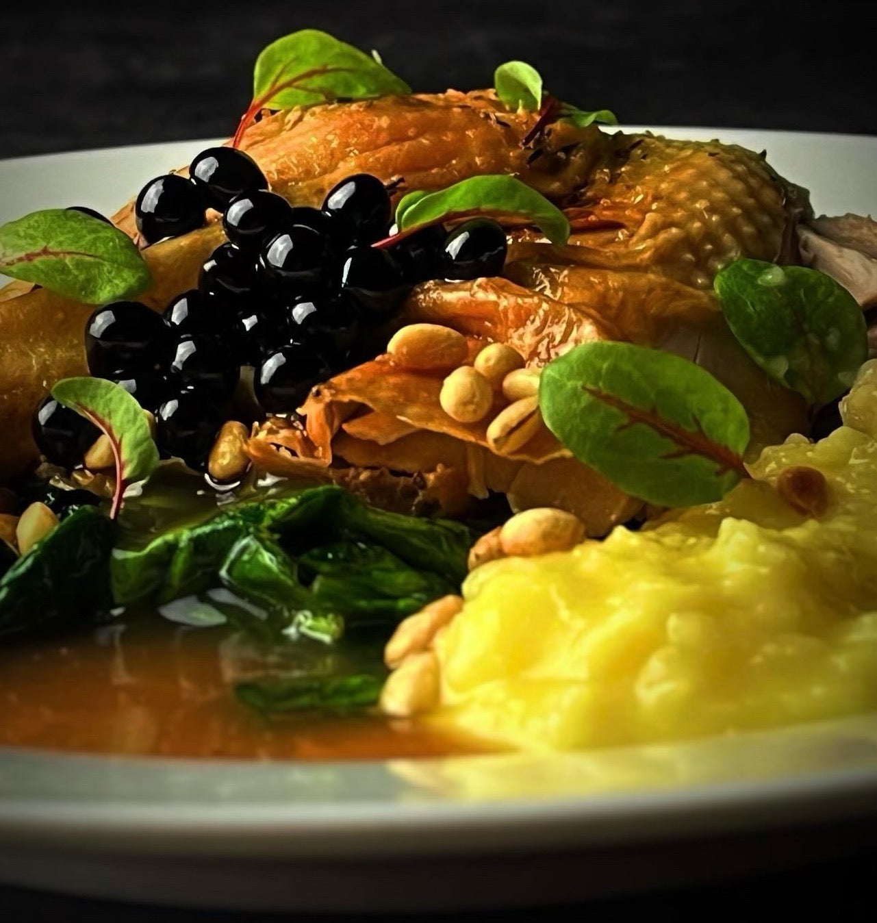 Sticky balsamic pearls over roasted vegetables and greens in a serving bowl
