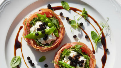 Sticky balsamic pearls on prosciutto cups with tomatoes, basil, and black pearls