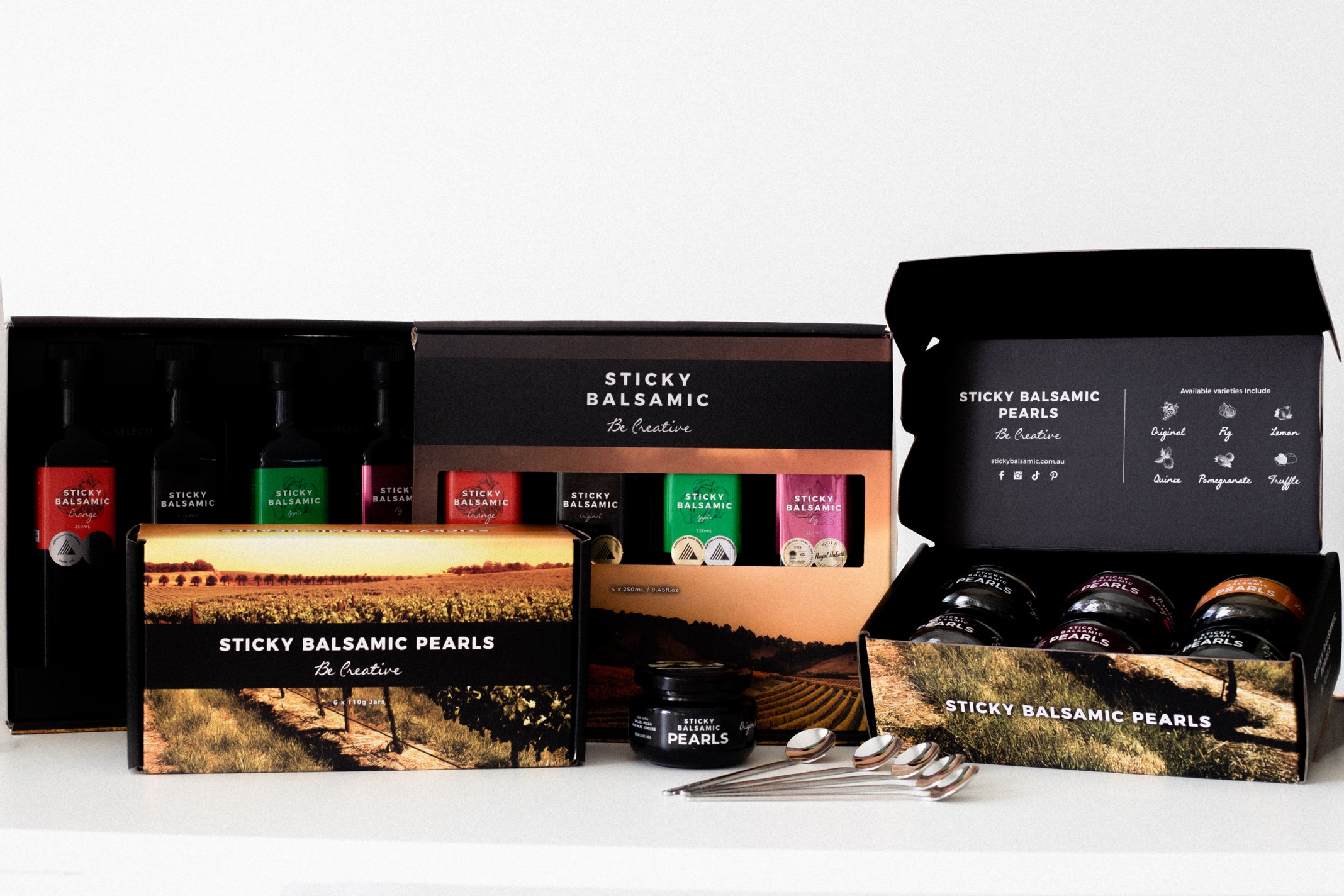 Sticky balsamic gift set with boxes, pearls, and small bottles in tray