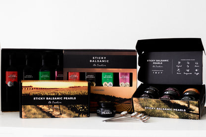 Sticky balsamic gift set with boxes, pearls, and small bottles in tray