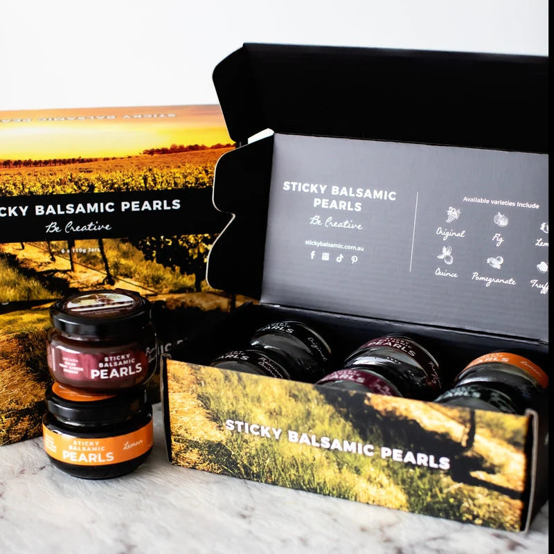 Sticky balsamic pearls gift box open with assorted jars and bottles for gifting